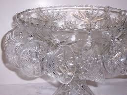 Crystal punch bowl with hanging cups, starburst pattern.