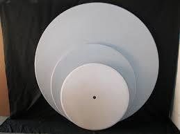 Four gray circular discs stacked on top of each other, each a different size.