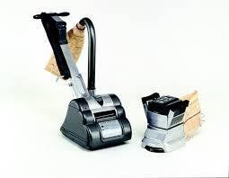 Floor sander and edger on a white surface. The sander is black and silver, and the edger is silver.