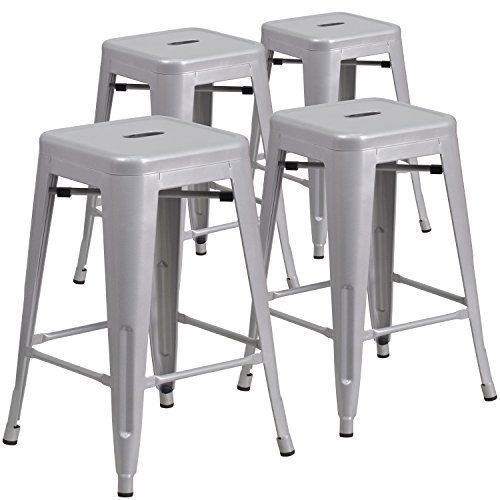 Four silver metal industrial bar stools.