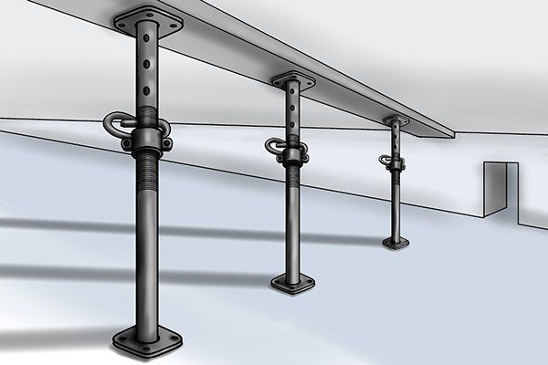 Metal support posts holding up a concrete structure during construction.