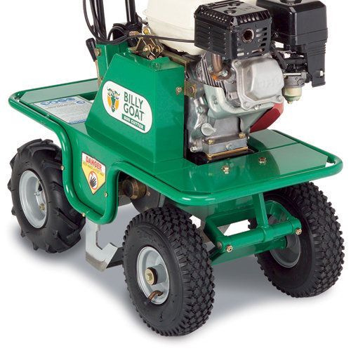 Green Billy Goat aerator with a gas engine and four black tires on a white background.