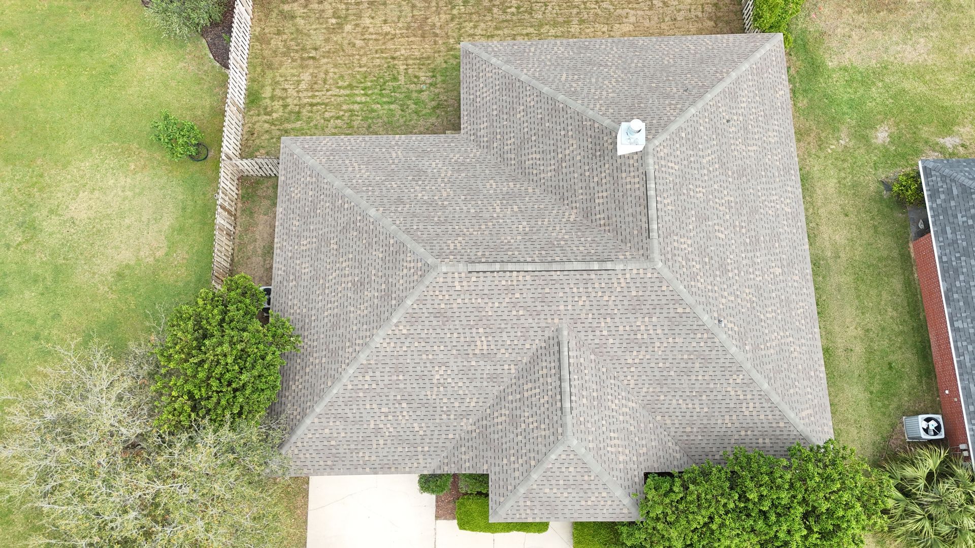 Overhead view of a house in Gulf Breeze, FL with a new roof installed by Coastal Family Roofing