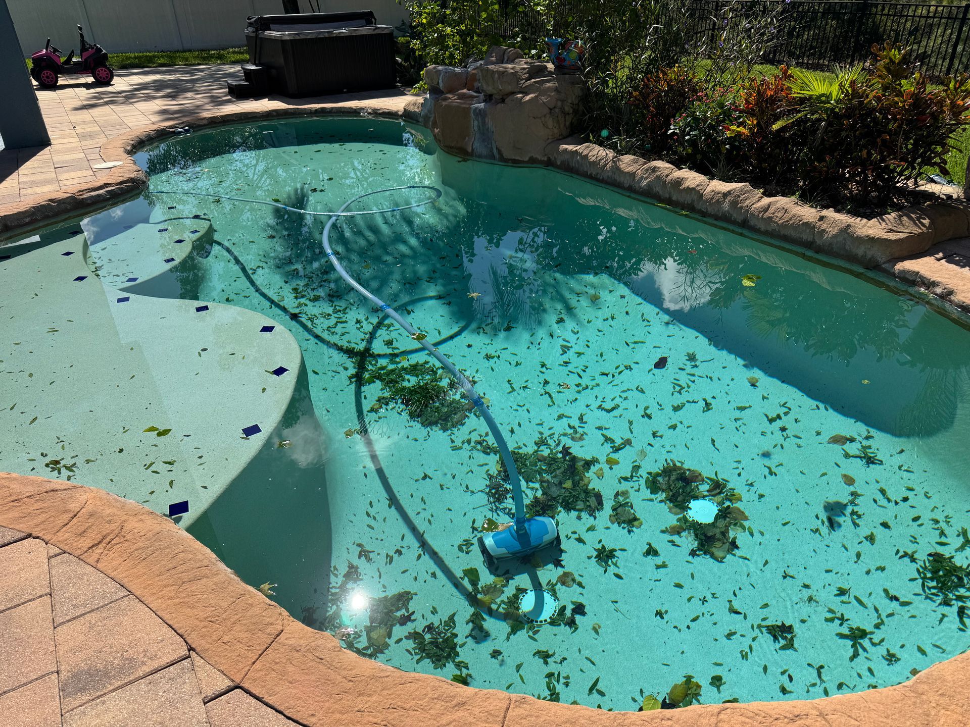 A swimming pool with a lot of leaves in it