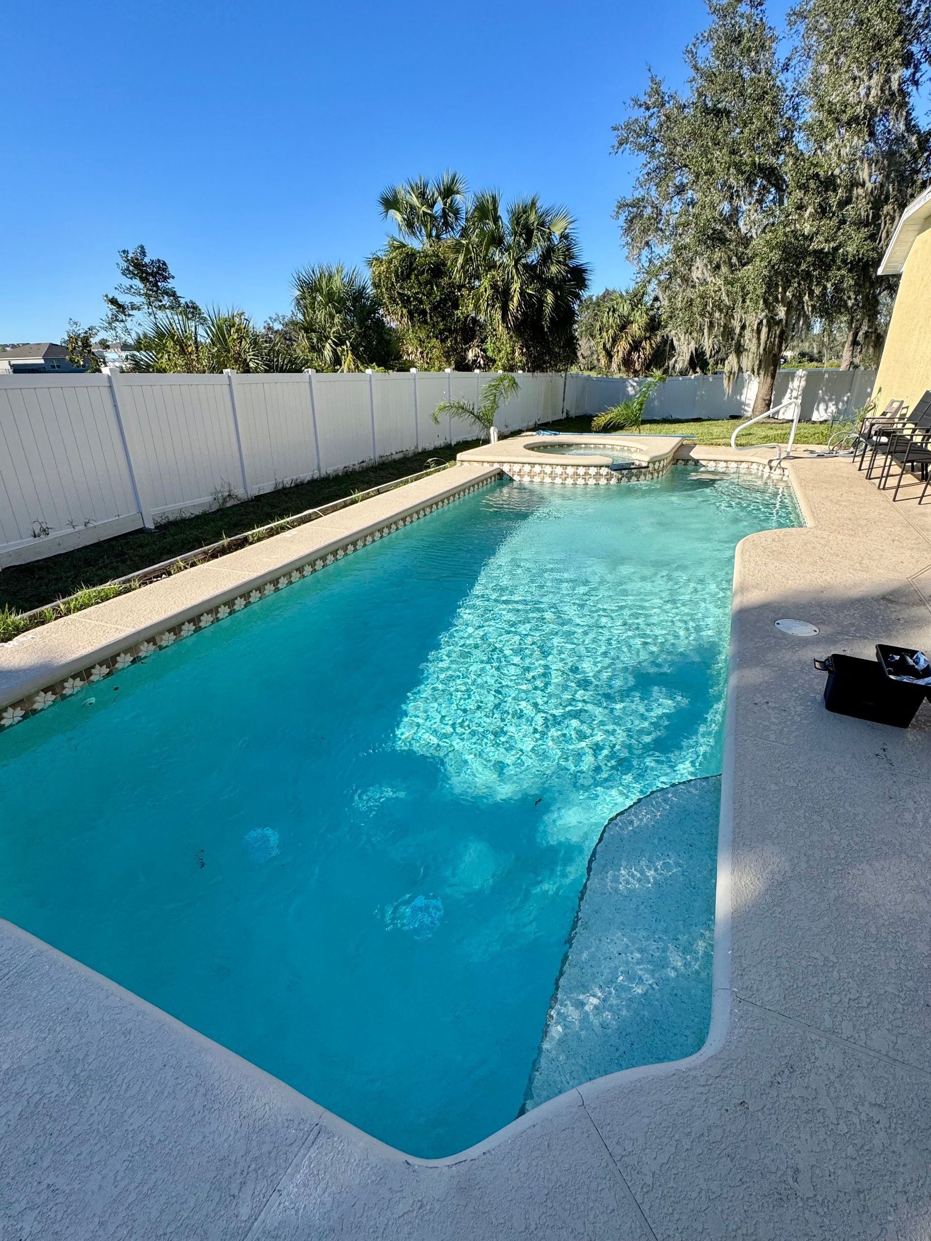A swimming pool with a vacuum cleaner attached to it.