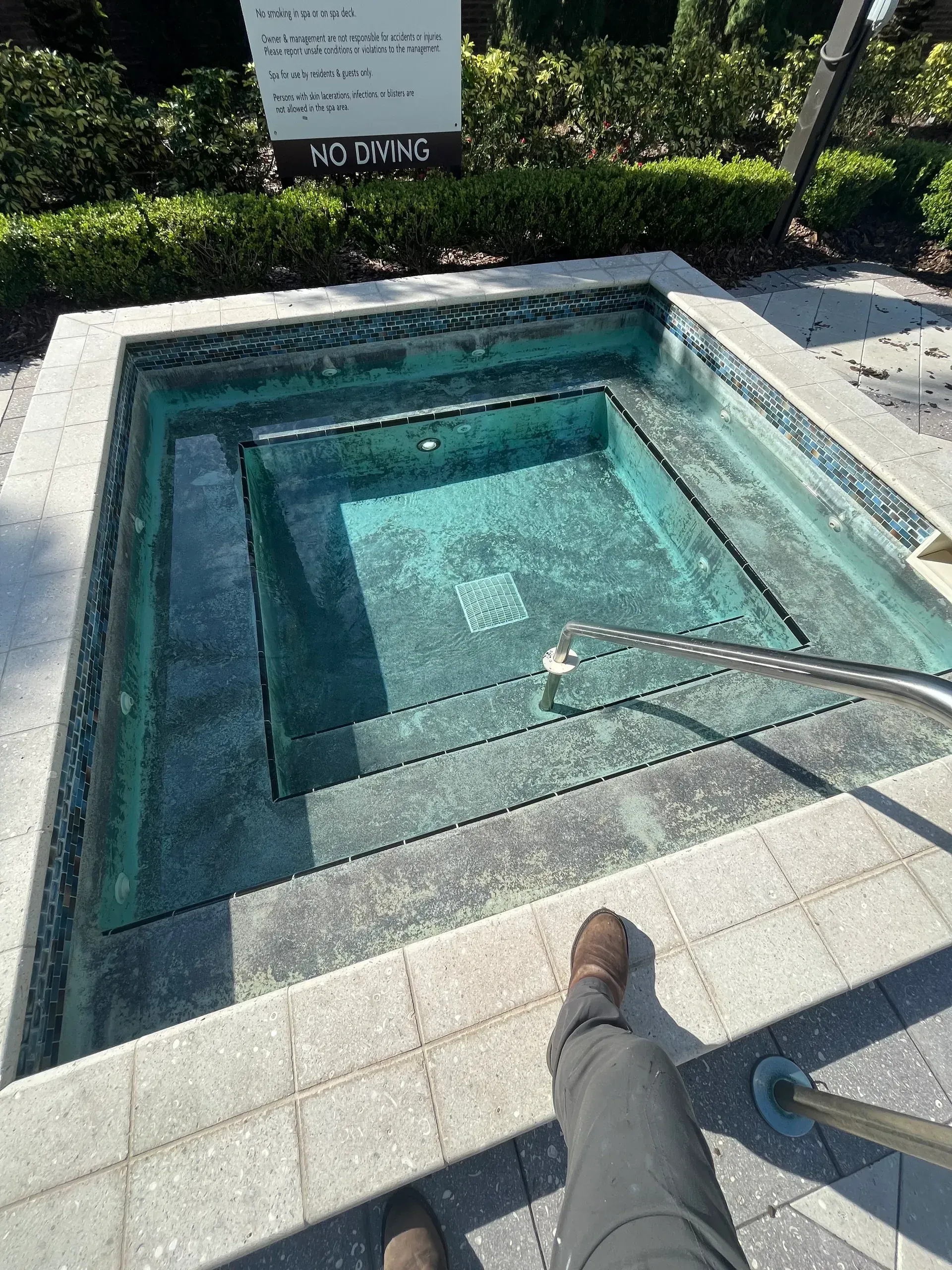 A person is standing in front of a hot tub.