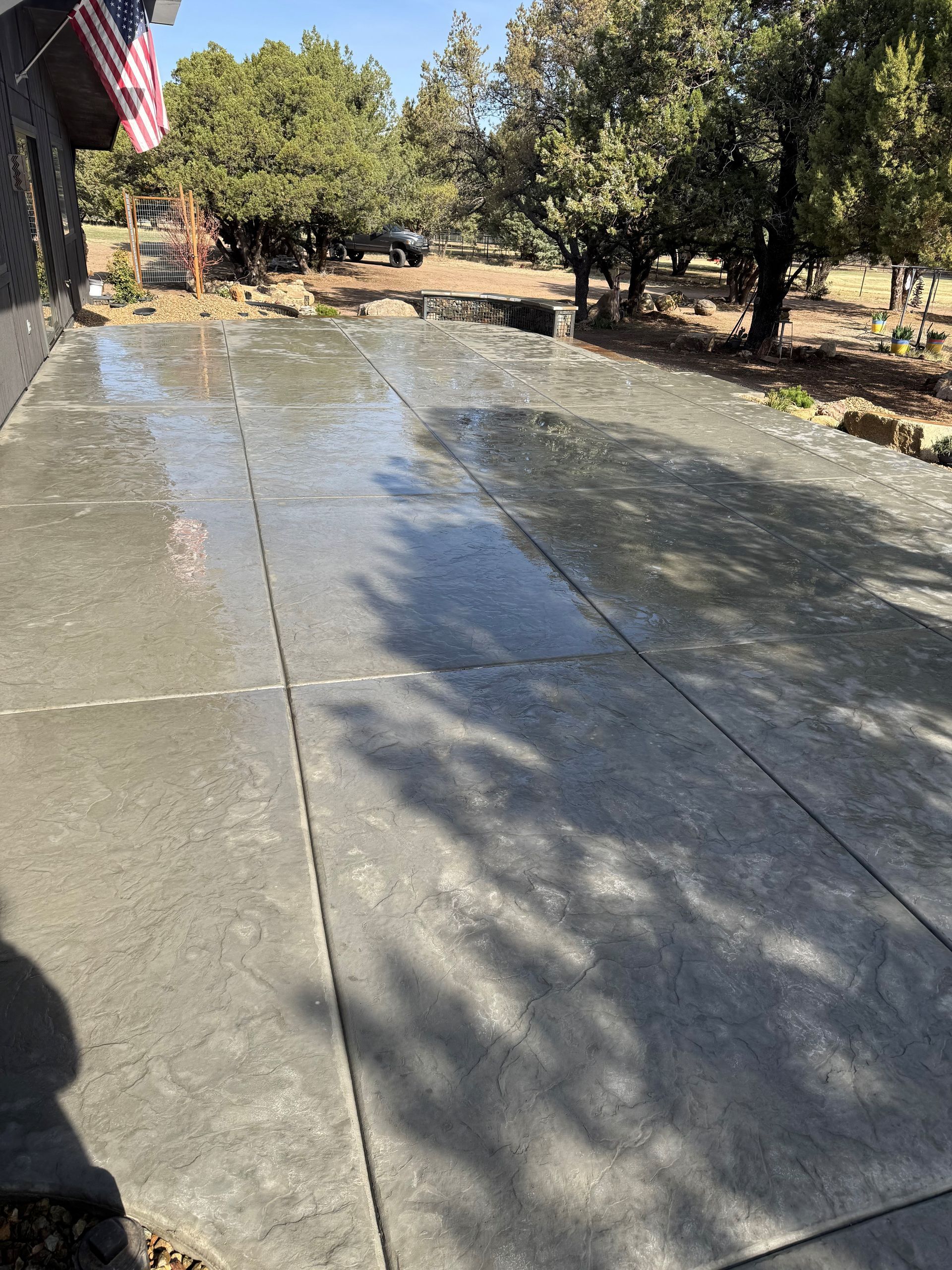 A concrete driveway is being built in front of a house
