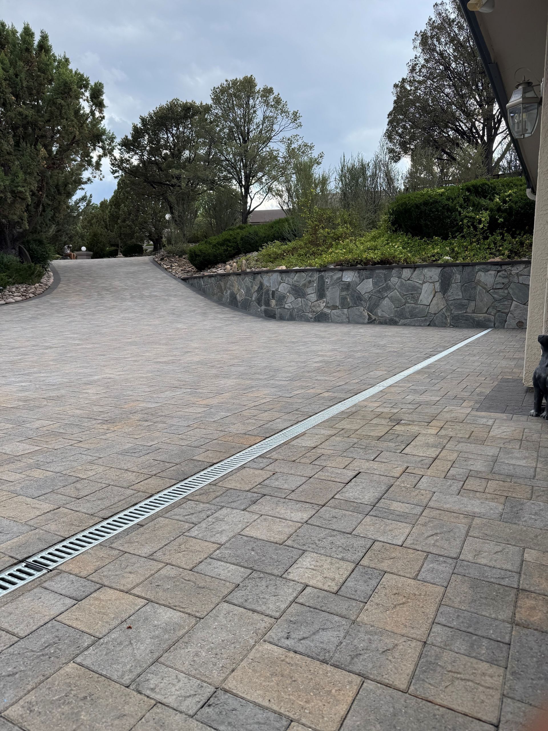 A concrete walkway is being installed in front of a house.