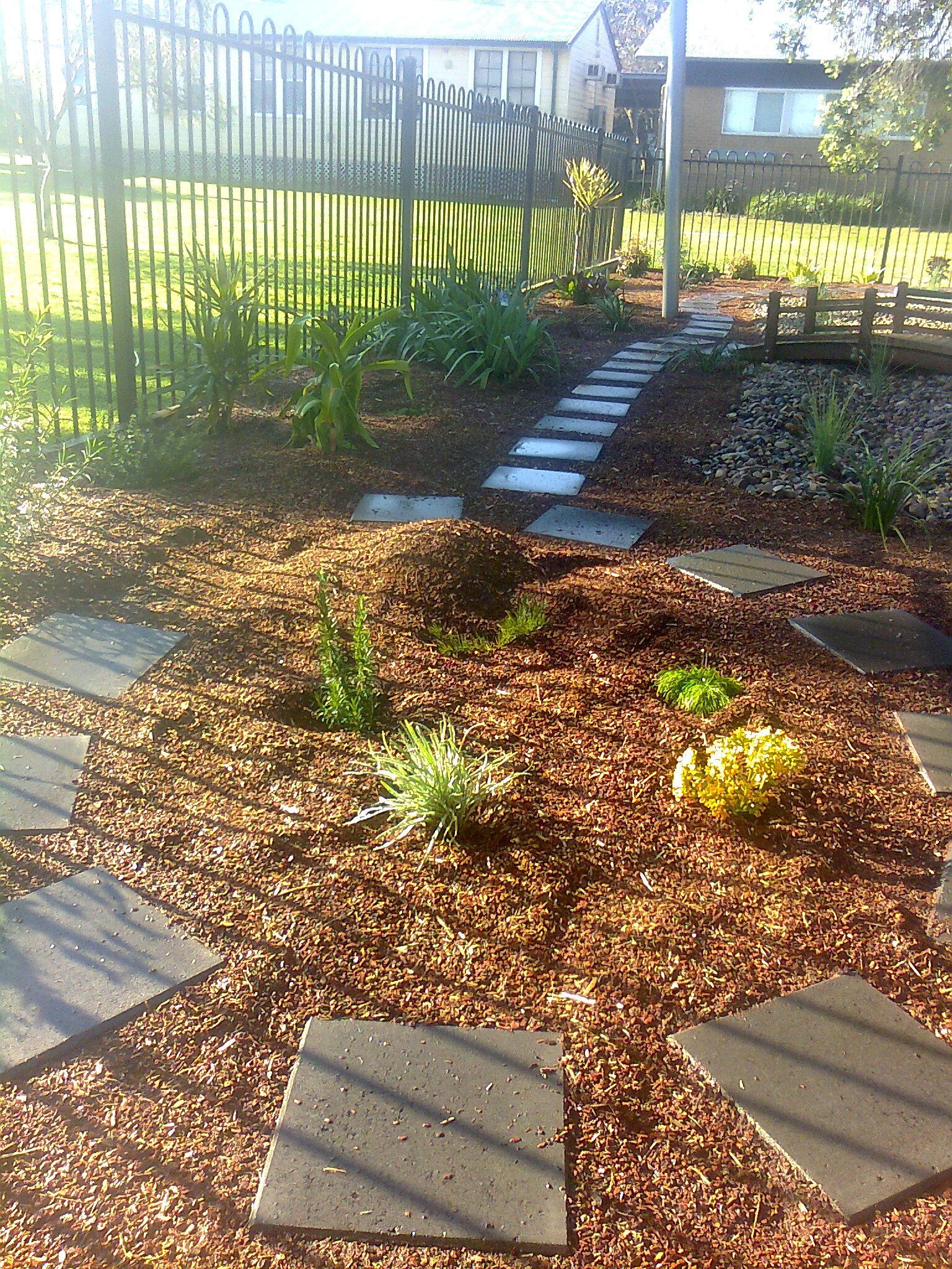 A garden is surrounded by bark and plants — Creating Eden Landscaping In Lake Macquarie, NSW