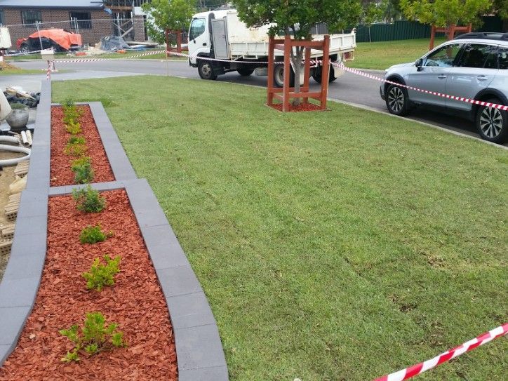 Freshly Laid Green Lawn and Garden Bed With Red Mulch — Creating Eden Landscaping In Speers Point, NSW