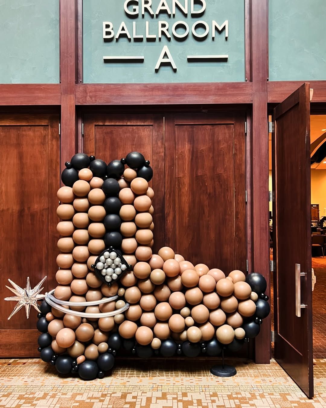 A cowboy boot made out of balloons in front of the grand ballroom a
