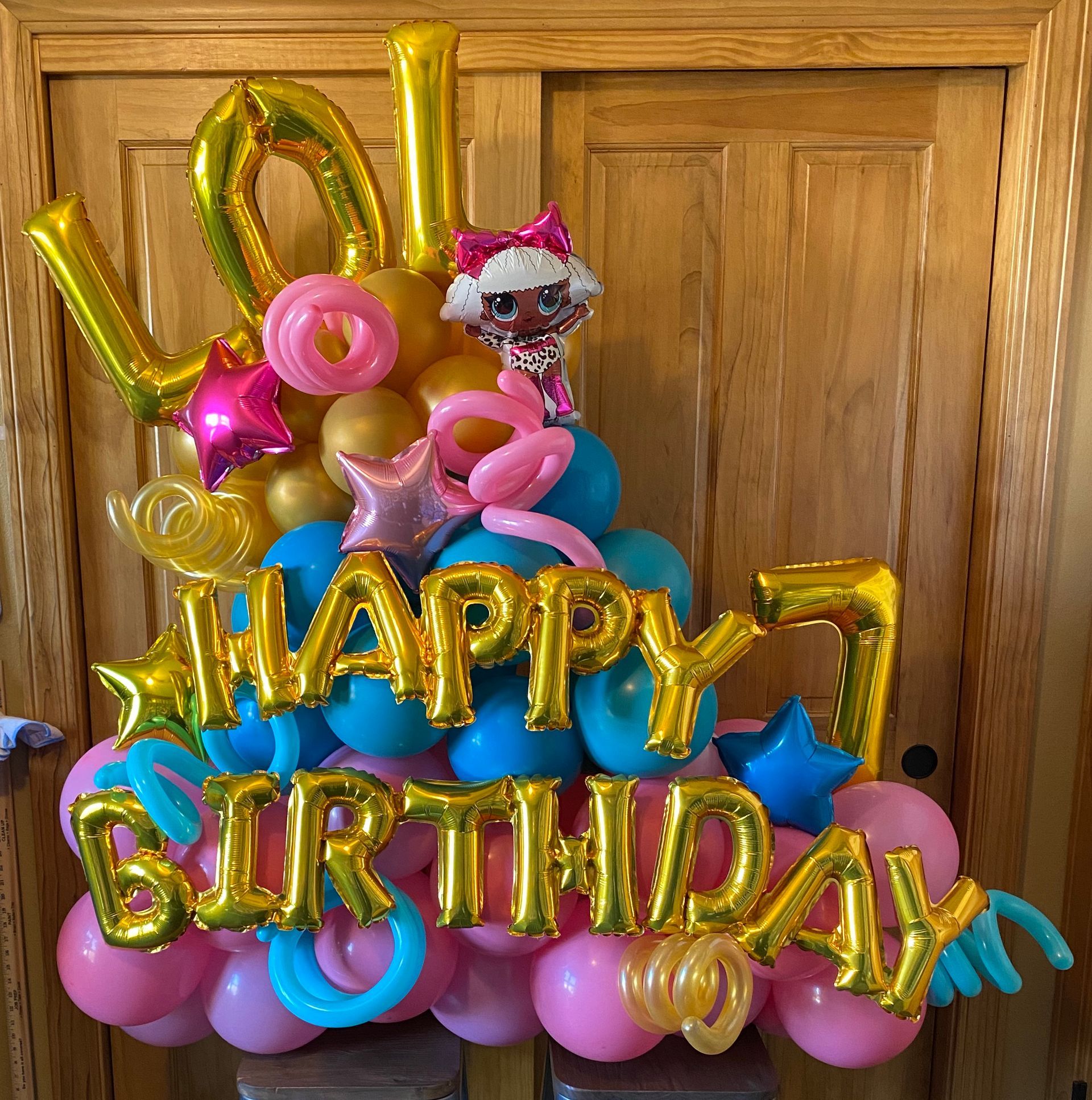 A bunch of balloons that say happy 7th birthday
