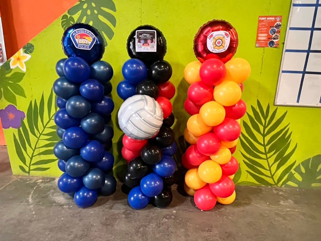 Three columns of balloons with volleyballs on top of them