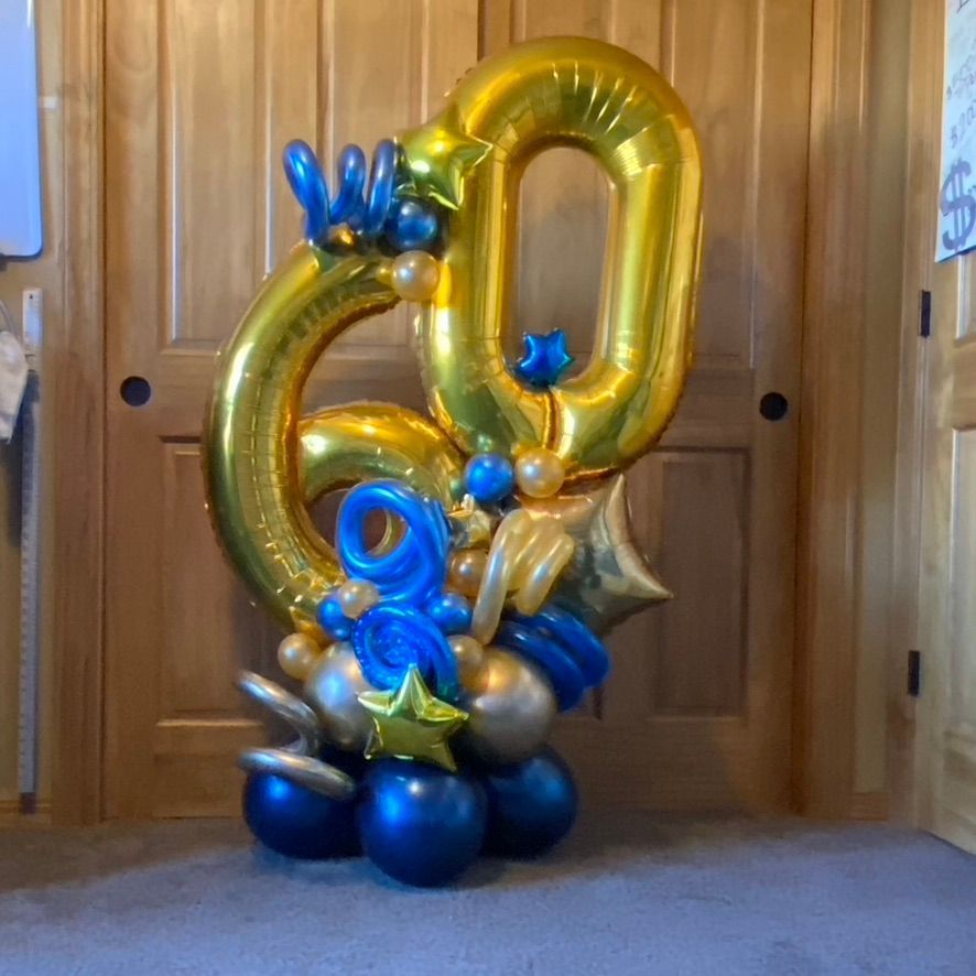 A bunch of blue and gold balloons shaped like the number 60