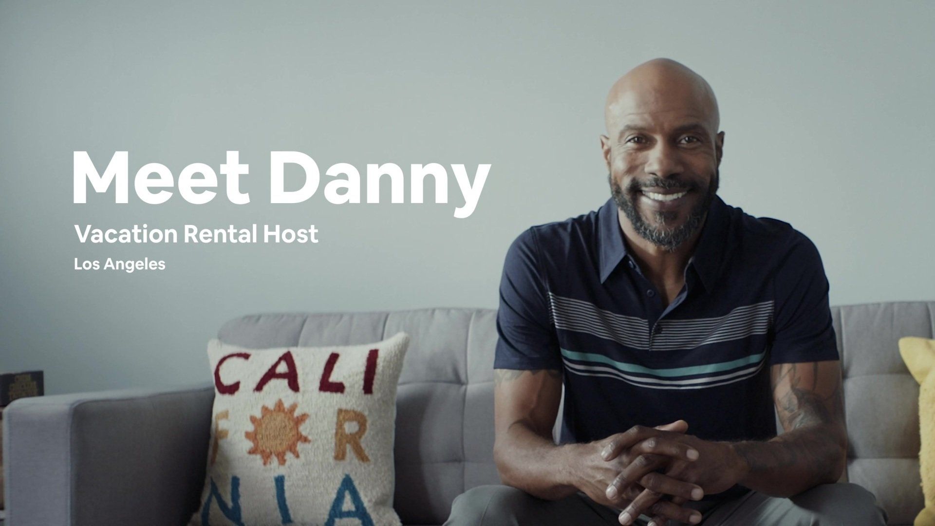A man, Danny, sits on a couch in Los Angeles. Text: Meet Danny, Vacation Rental Host.