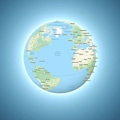 A globe with a map of the world, in shades of blue and green, on a light blue background.