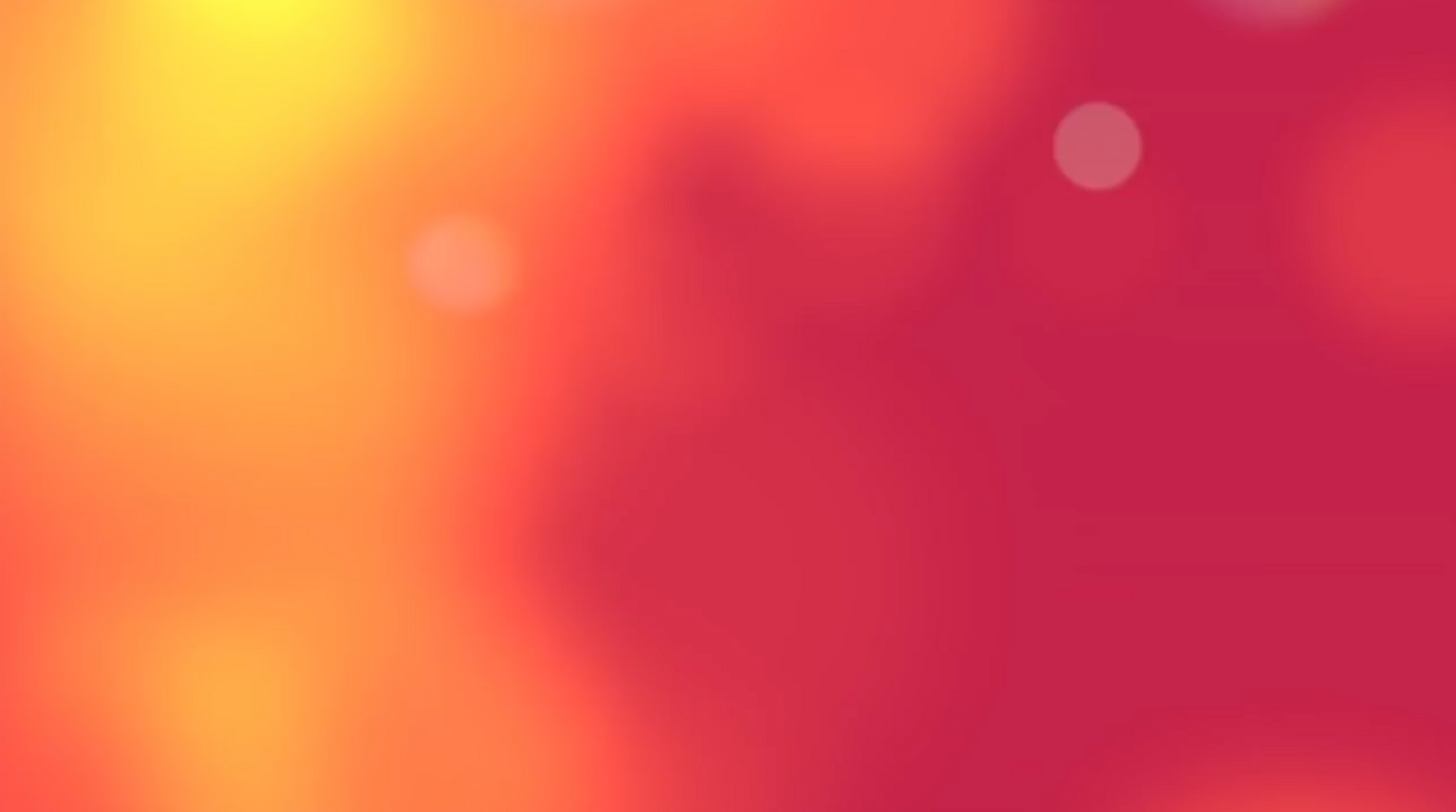 Warm gradient of yellow, orange, and red with blurry white circles.