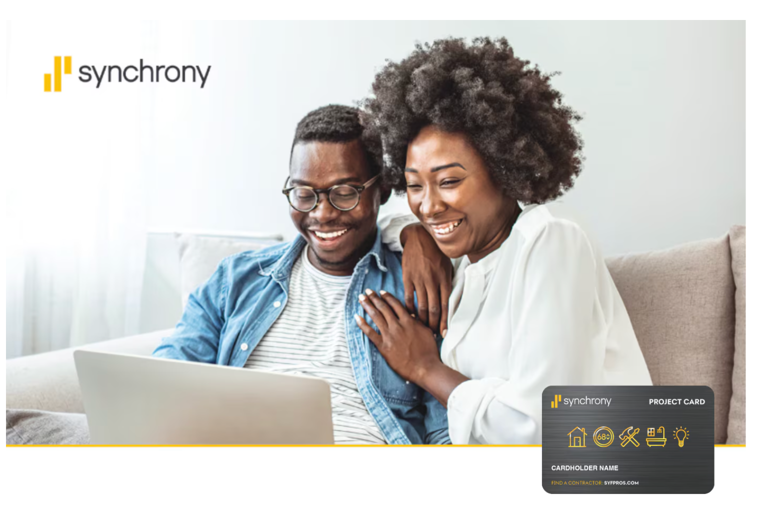 Couple smiling on a couch using a laptop, with a Synchrony credit card logo in the corner