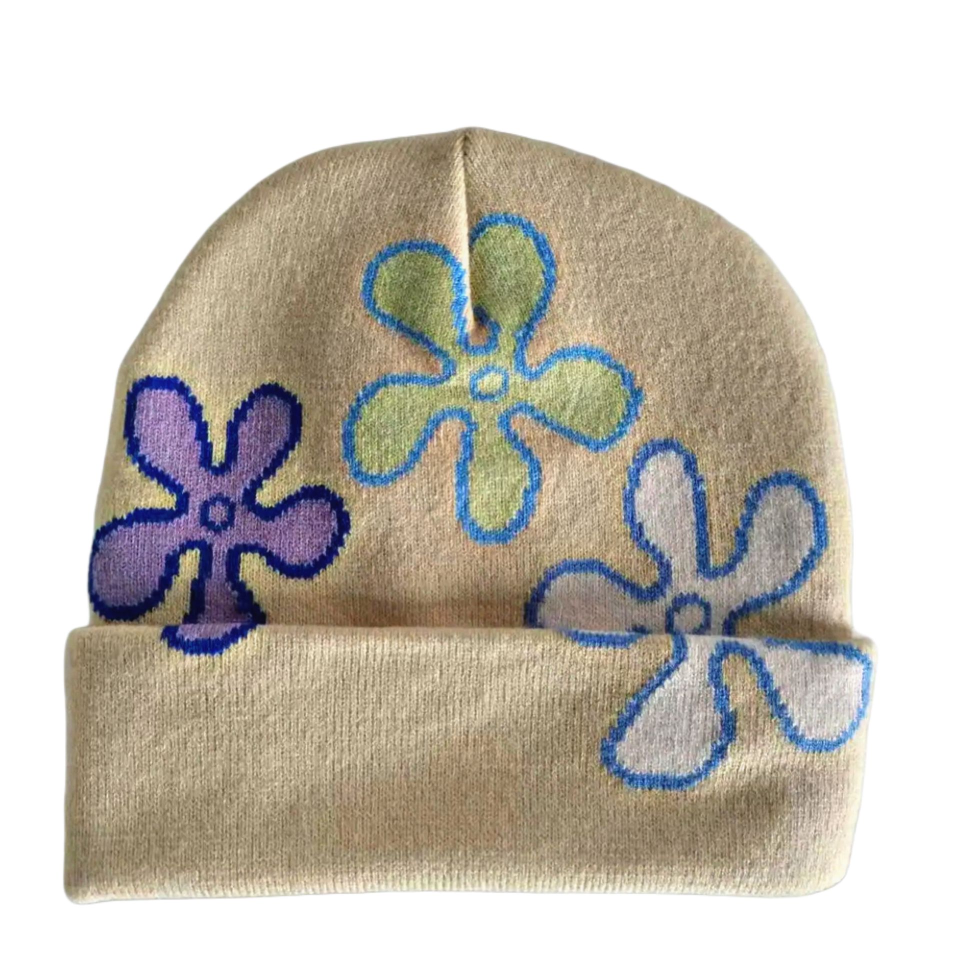 Beige beanie with purple, green, and blue flower patterns and a black-and-white logo patch.