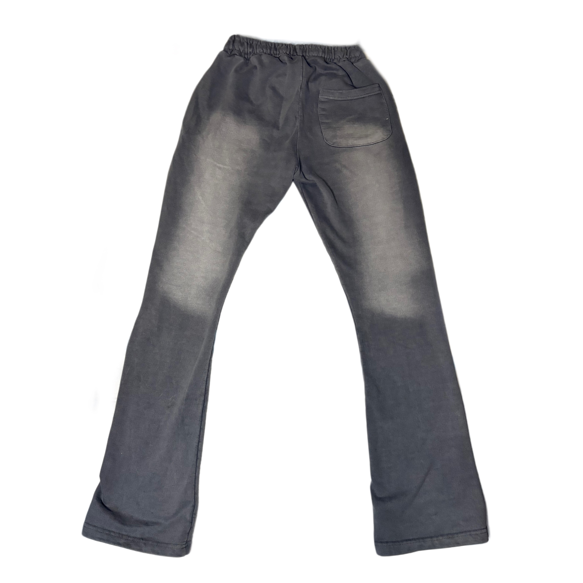 Black sweatpants with red graphic designs on the thighs, laid flat on a white background