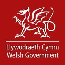 Welsh Government logo: white dragon on red background, with Welsh and English text below.
