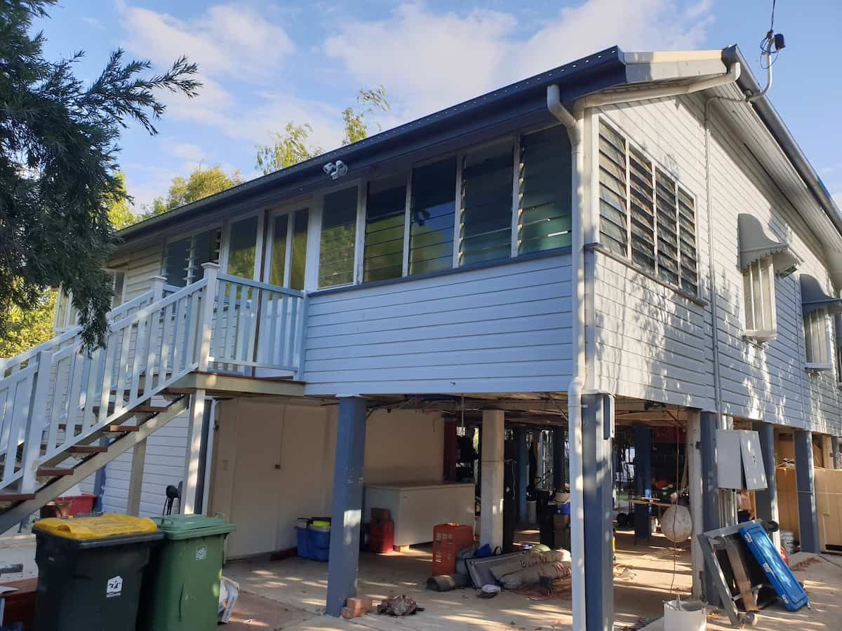 A White House With a Blue Deck and Stairs — Gaspen Builders & Carpenters in Kirwan, QLD