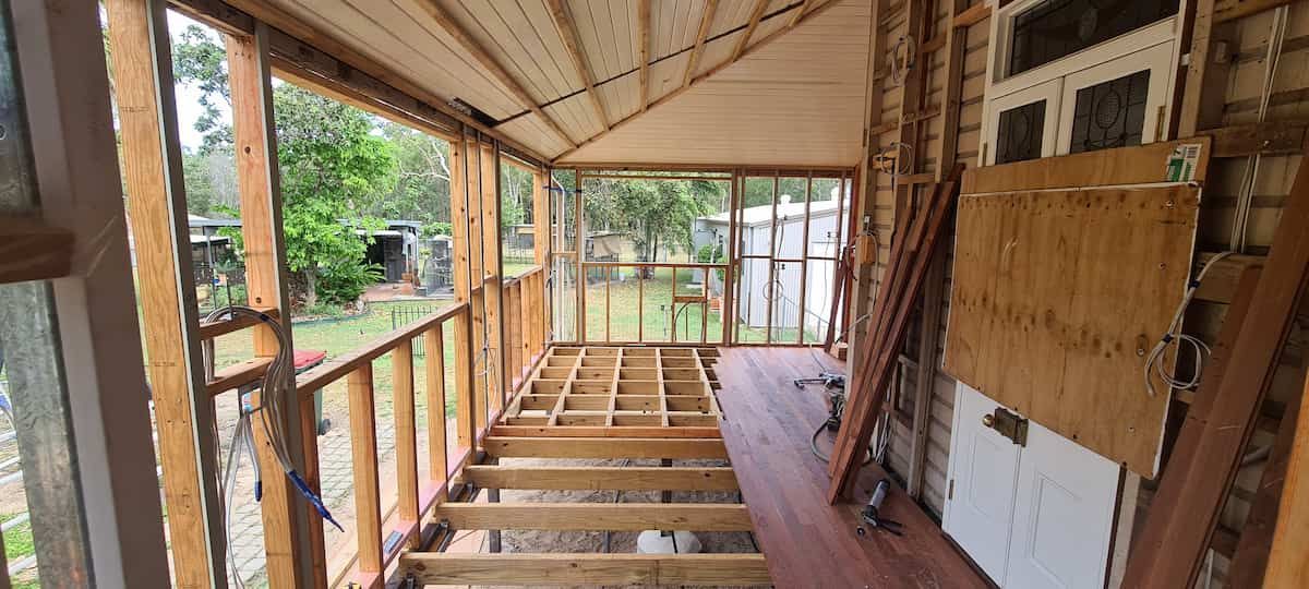 A Room With a Wooden Floor and a Wooden Table in It — Gaspen Builders & Carpenters in Kirwan, QLD