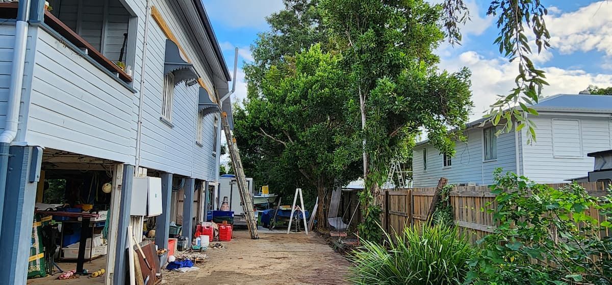 A Row of Houses Sitting Next to Each Other on a Dirt Road — Gaspen Builders & Carpenters in Kirwan, QLD