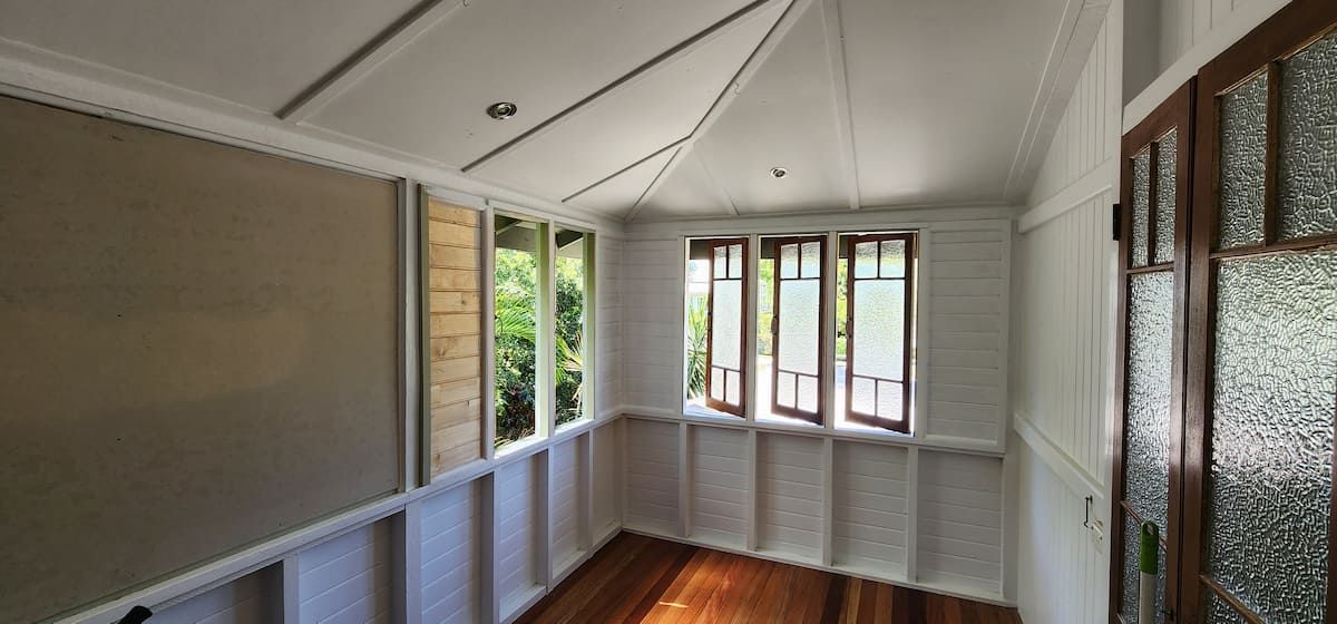 A Room With a Lot of Windows and a Wooden Floor — Gaspen Builders & Carpenters in Kirwan, QLD