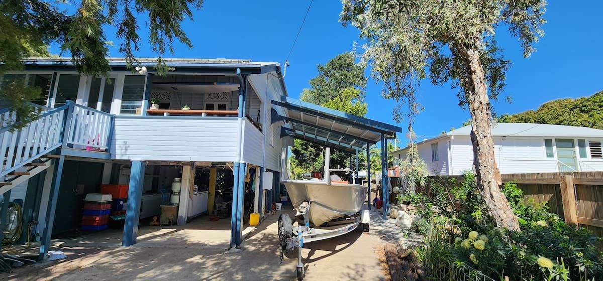 A Boat is Parked Under a Porch in Front of a House — Gaspen Builders & Carpenters in Kirwan, QLD