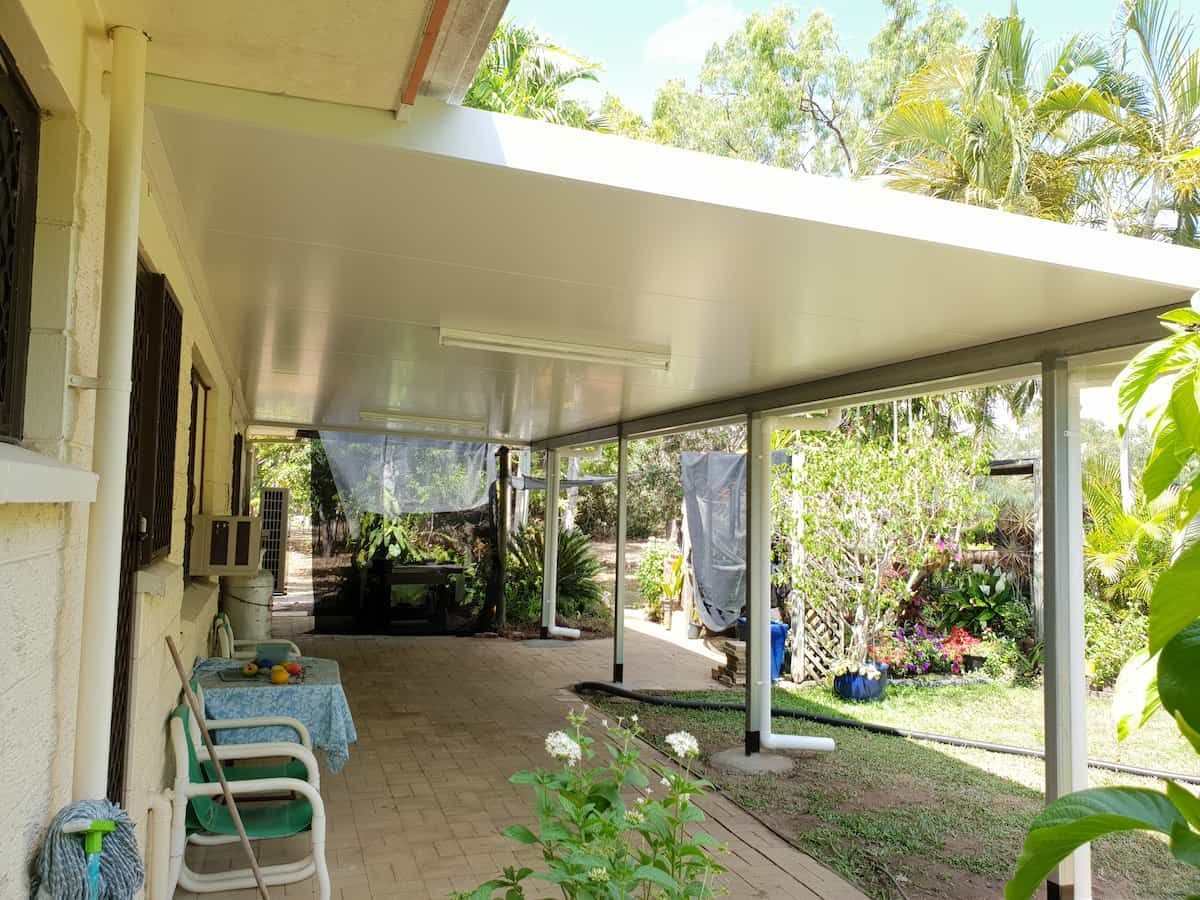 There is a Covered Porch With a Table and Chairs Underneath It — Gaspen Builders & Carpenters in Kirwan, QLD