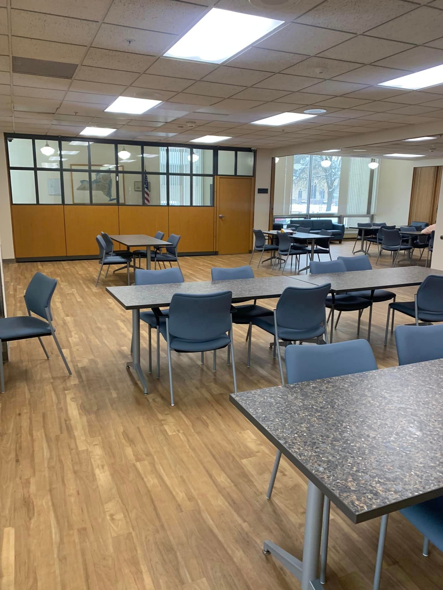 A large room with tables and chairs in it