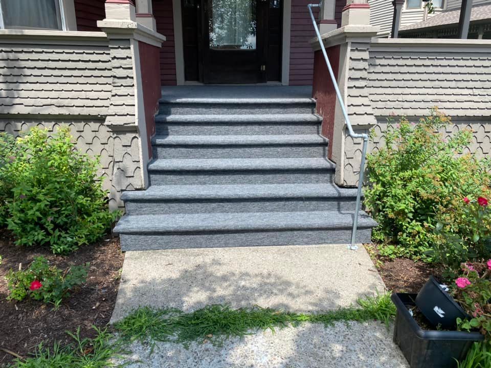 A set of stairs leading up to the front door of a house.