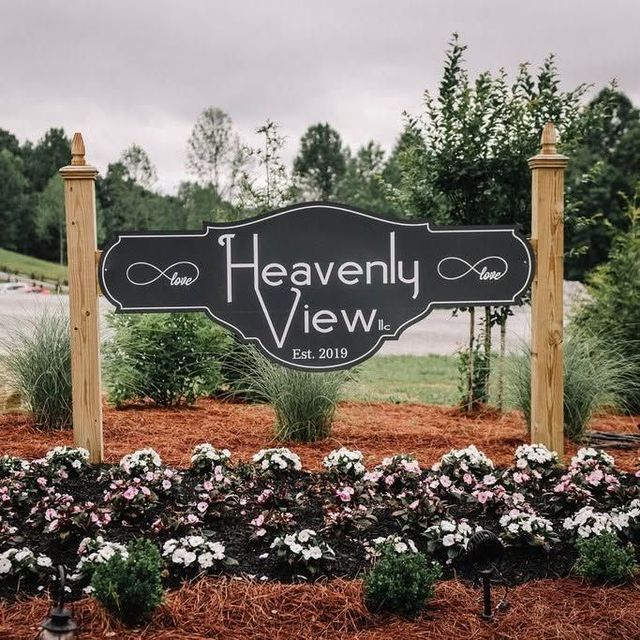“Heavenly View” sign in a landscaped garden with flowers and trees