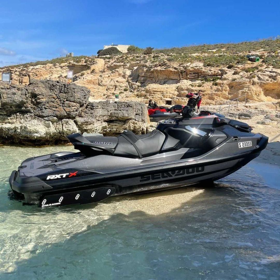 A sea doo jet ski is parked on the beach.