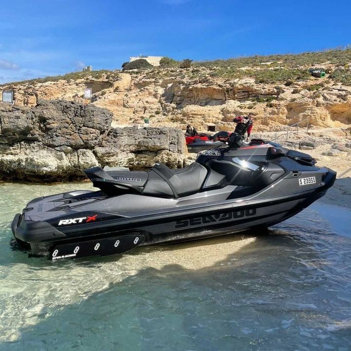 A sea doo jet ski is parked on the beach.