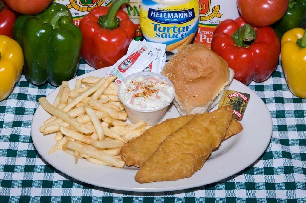 Plate with fried fish, fries, coleslaw, burger, and condiments, surrounded by vegetables.