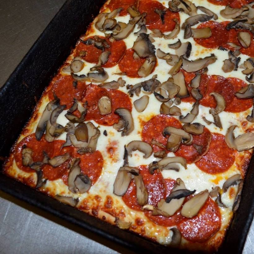 Square pizza with pepperoni and mushrooms.