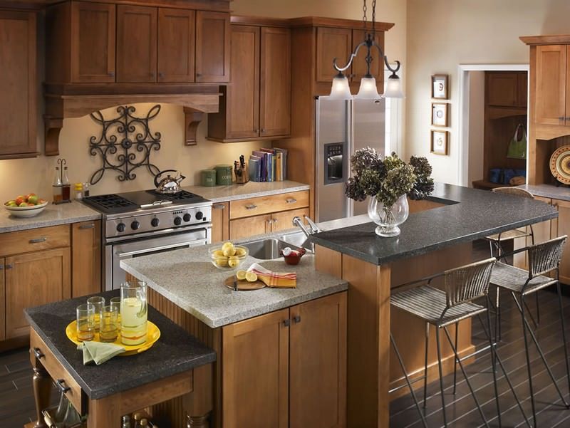 Modern kitchen with wood cabinets, island, stainless appliances, and black countertops