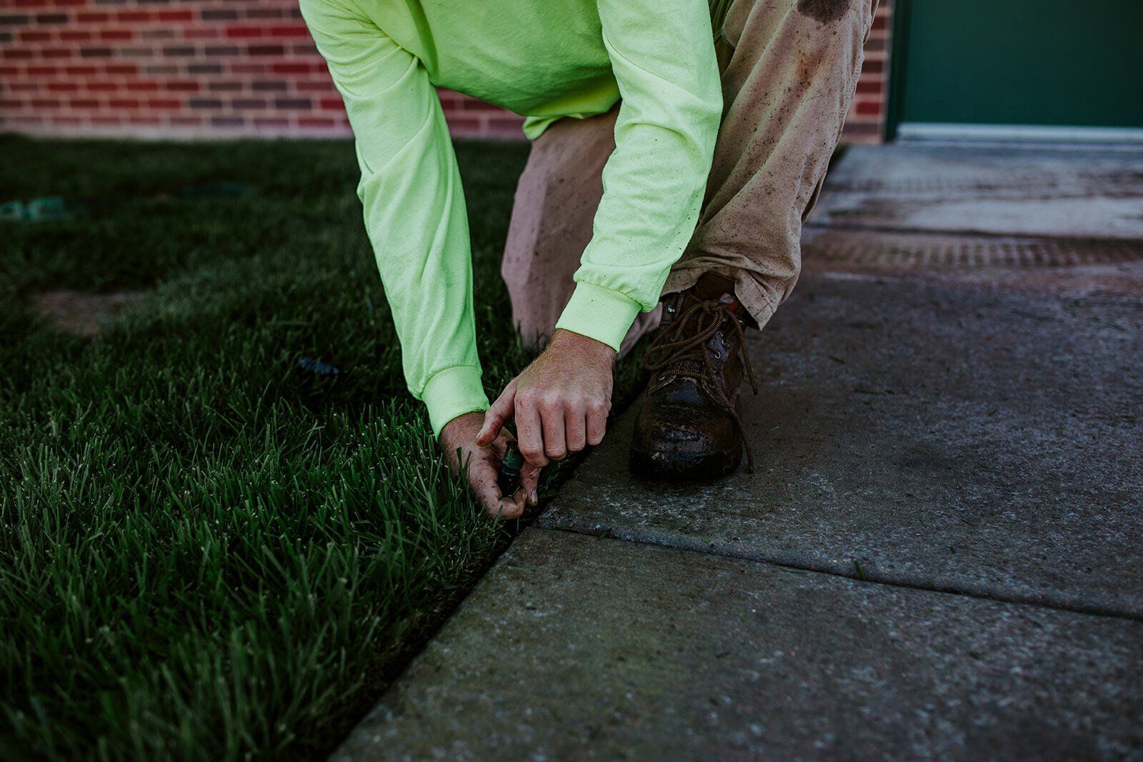 Person checking irrigation system