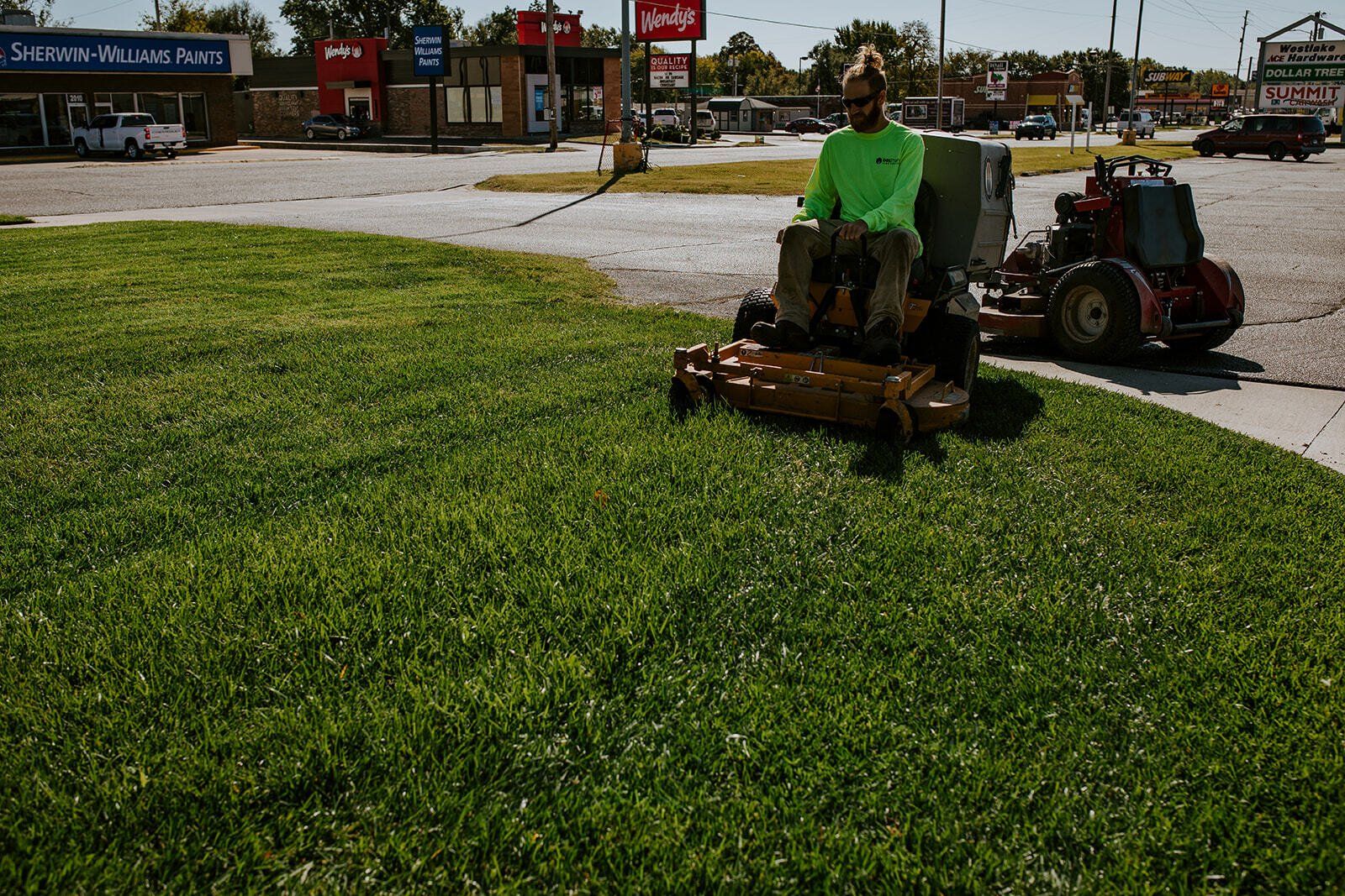 Boxman Lawn Care Expert Mowing a Lawn