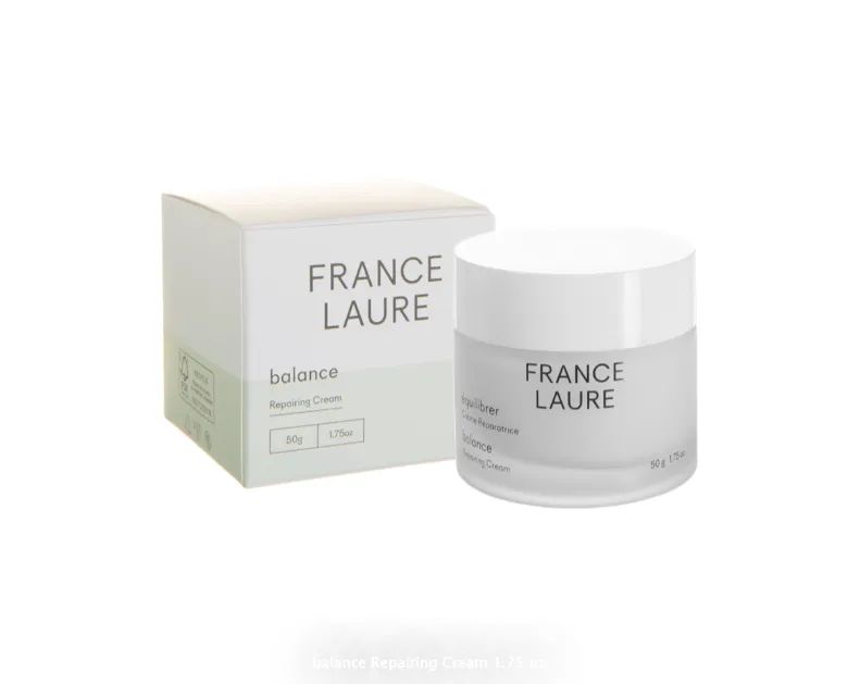 A white jar of france laure cream next to a white box.