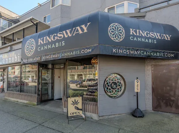Kingsway Cannabis storefront with blue awning and open entrance on a city street