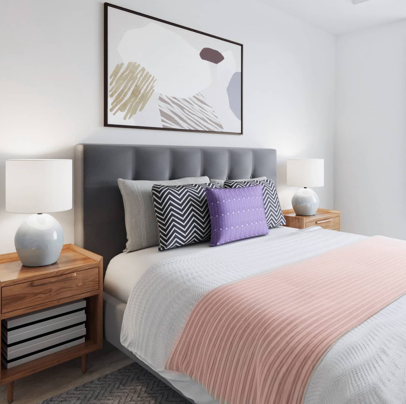 Bedroom with gray tufted headboard, two nightstands, and abstract art above the bed.