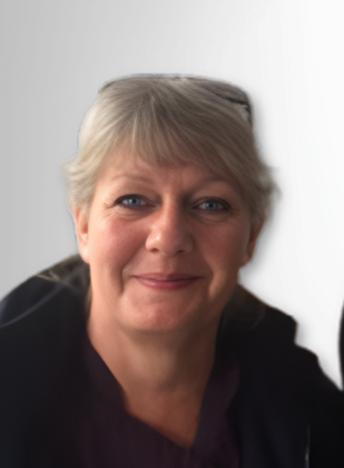 Woman with short gray hair smiles at the camera, wearing dark clothing.