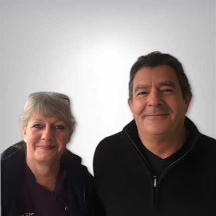 Gary & Sue McIndoe, posing in front of a white gradient background.