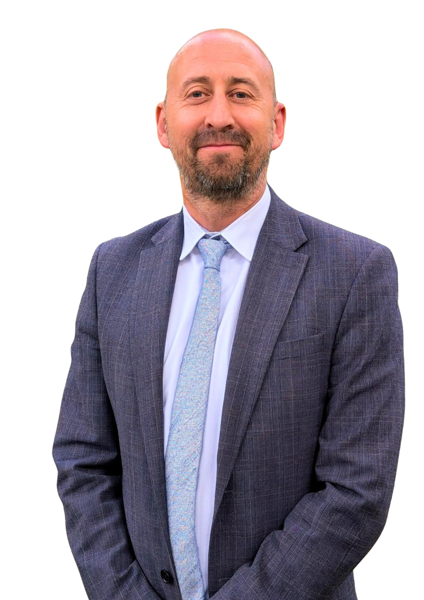 Man in a gray suit and tie, smiling against a plain white background