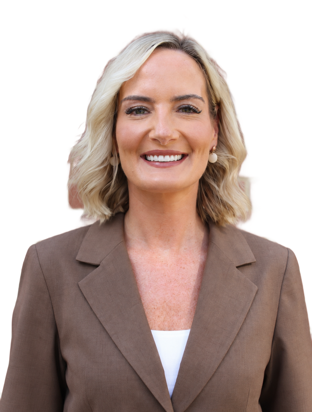 Portrait of a smiling woman in a light blue blazer and polka dot blouse against a white background
