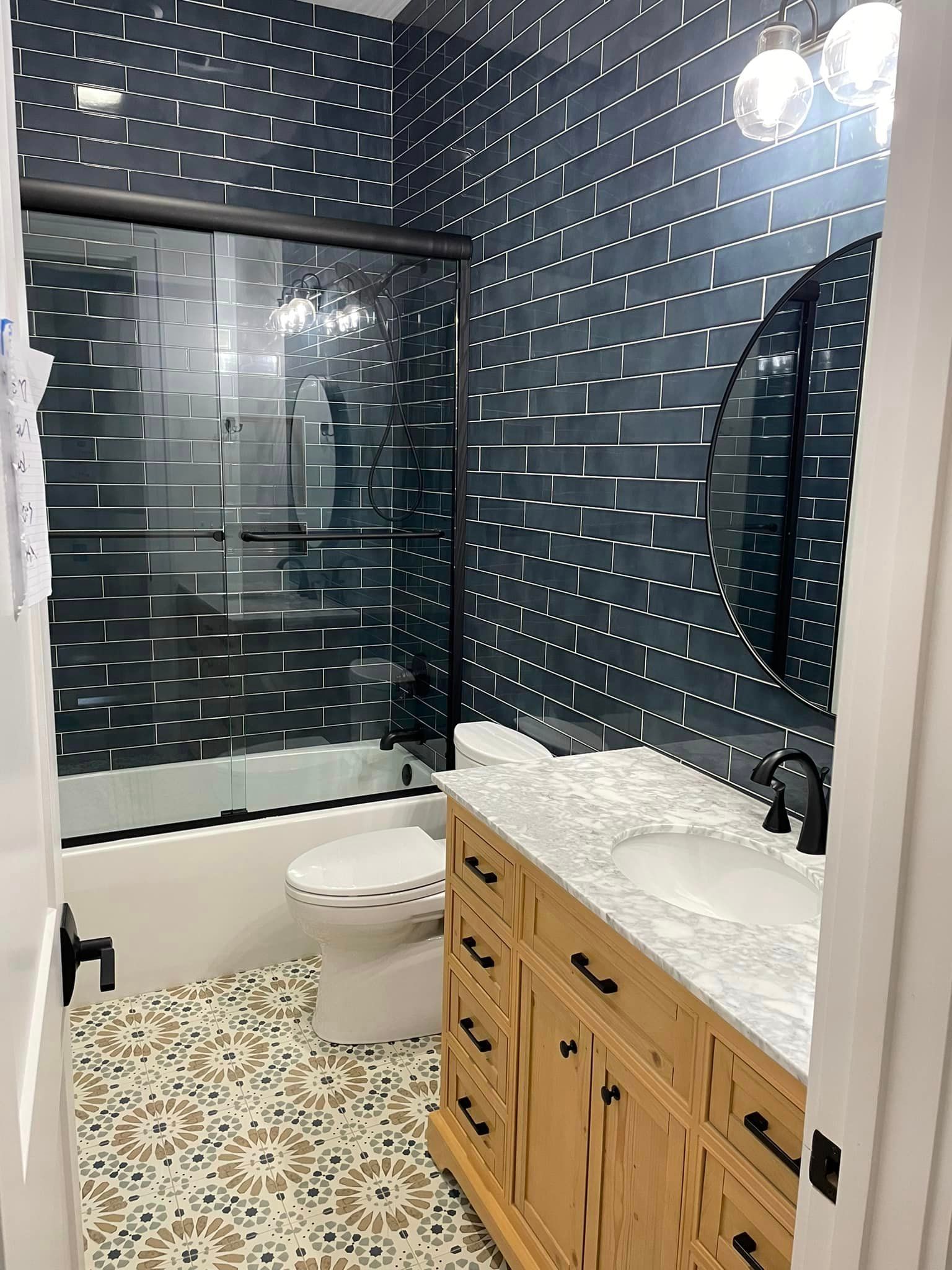 A bathroom with a toilet , sink , and bathtub.