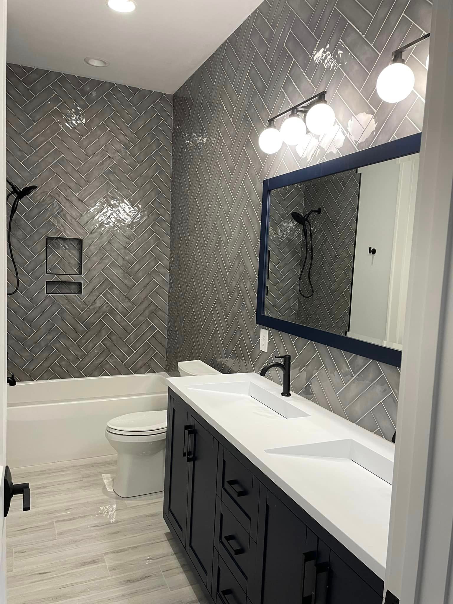 A bathroom with two sinks , a toilet , and a bathtub.
